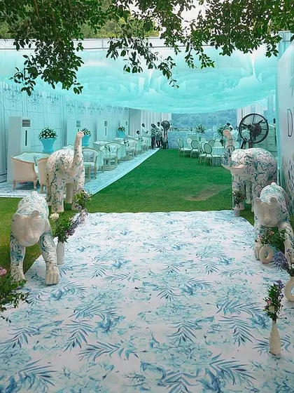 For a bride who loves high fashion, I designed a Mehendi inspired by Dior's iconic patterns. This entrance features custom-painted animal sculptures, setting the stage for a chic, couture-themed afternoon.