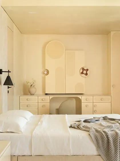 The full view of the master bedroom, where the custom joinery, arched headboard, and serene color palette combine to create a minimalist yet warm retreat.
