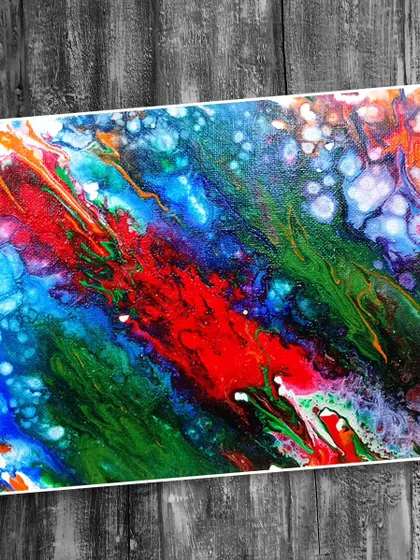 An abstract fluid artwork with a cosmic feel, created using different pouring methods. Explore the universe of color and texture in our fluid art sessions.