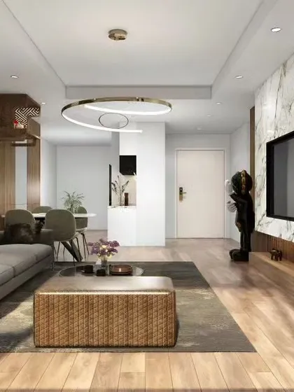 A contemporary open-plan living and dining area with a cohesive design. The TV wall features a marble-finish panel and wood accents, which are echoed in the dining space partition for a harmonious look.