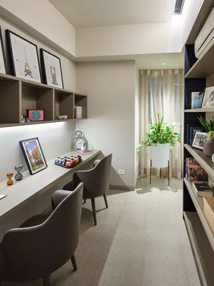 A compact and efficient home study nook with built-in shelving and integrated lighting. This space demonstrates how a functional workspace can be seamlessly integrated into a larger room.