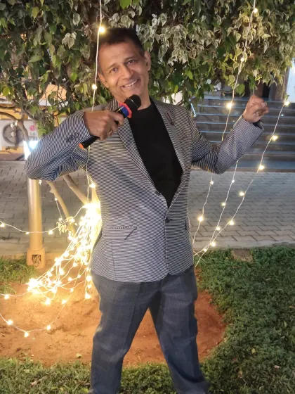 Hosting an evening event outdoors. The festive lights create a great atmosphere, and I'm here to make sure the energy of the party matches the beautiful setting.
