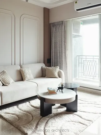This bright and airy living room at Sai World Empire opens onto a balcony, flooding the space with natural light. The neutral color scheme enhances the sense of spaciousness and tranquility.