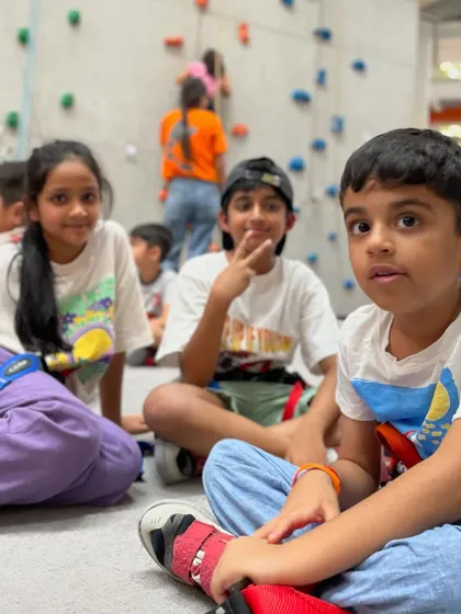 A group of kids takes a break between climbs. The social aspect of our youth programs is key to building a supportive and fun community.