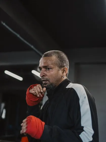 A fighter with his hands wrapped, focused and ready for shadowboxing or pad work.