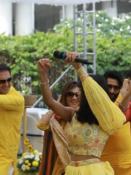 Leading the dance moves at a Haldi function, ensuring everyone is involved.