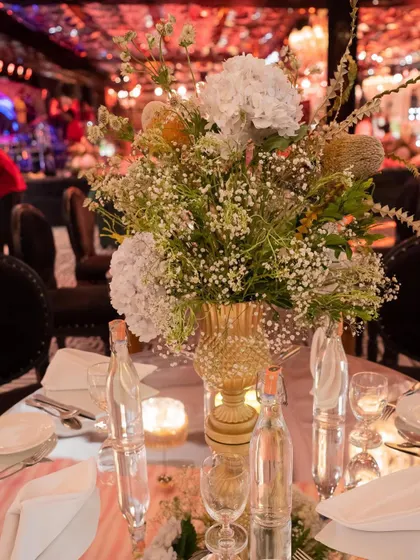 A beautiful floral centerpiece from the U+S Sangeet. The arrangement of white hydrangeas, baby's breath, and other delicate blooms added a touch of softness to the glamorous, high-energy event.