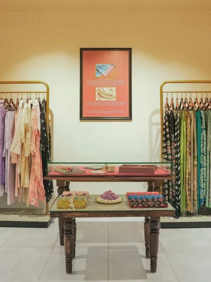A frontal view of the custom-made wooden display tables, designed to showcase smaller fashion accessories and folded garments.