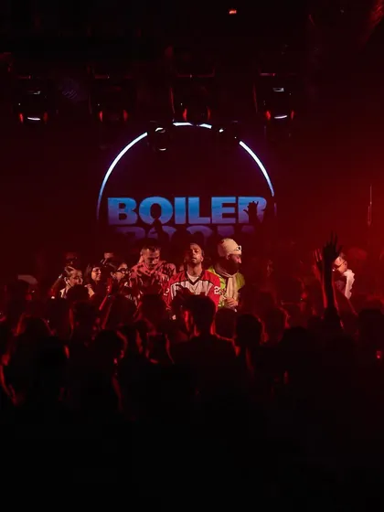 A dark, moody shot from a Boiler Room event, capturing the intense, focused energy of the room.