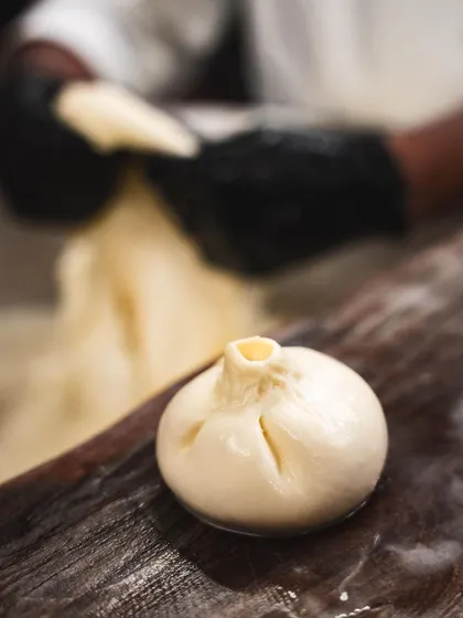 A freshly formed burrata, with its signature top knot. Each one is a small parcel of creamy delight, handmade in our kitchen.