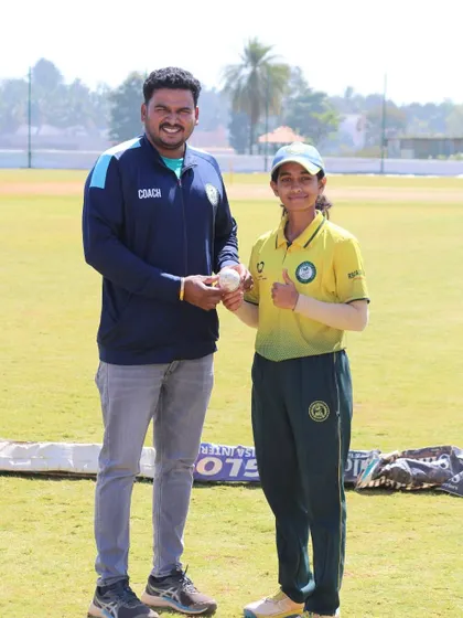 A coach congratulates a young player on her performance, a moment of mentorship and encouragement.