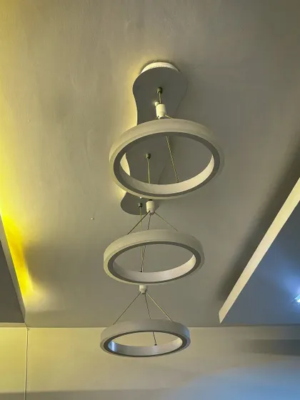 The same ring chandelier shown with warm lighting, demonstrating how the color temperature can change the mood of the room. I help clients choose the right lighting for their space.