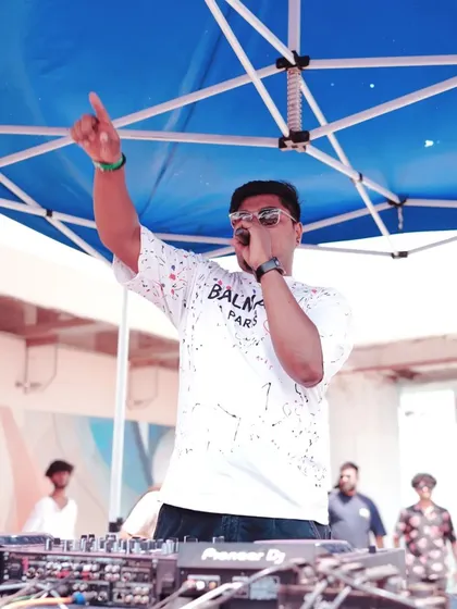 Another shot of me on the mic, leading the party from the DJ booth under the tent.
