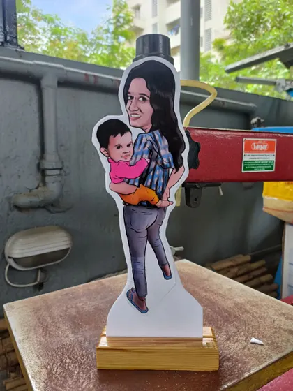 A miniature caricature cut-out of a mother and her child. These statues are a wonderful way to capture a precious family moment.
