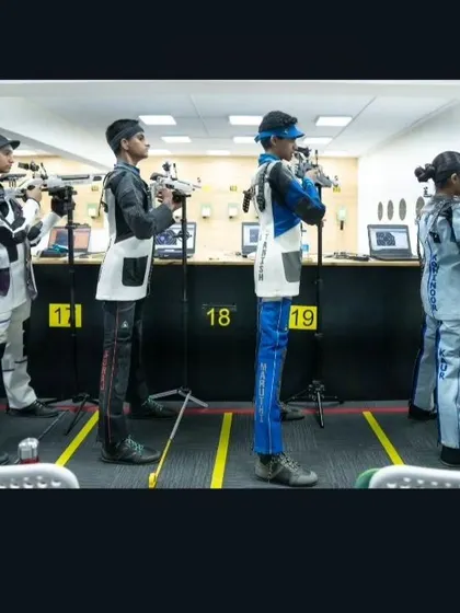 Shooters lined up during a competition, each displaying the unique stance and form required for high-level pistol and rifle events.