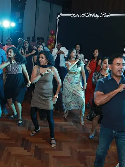 The start of a surprise flash mob for a 50th birthday party. I love getting a whole group of non-dancers in on the secret and choreographing a routine that gets everyone on the dance floor.