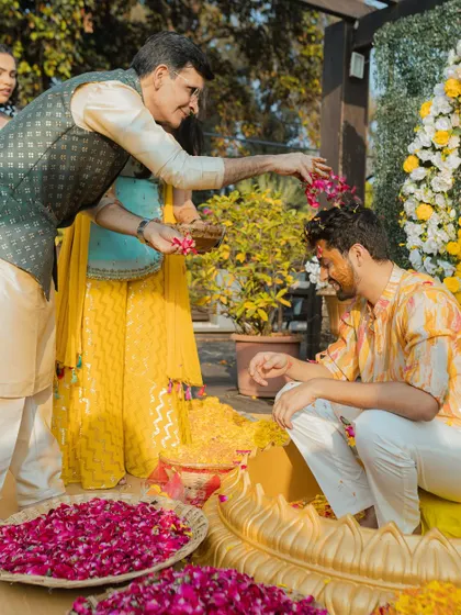 A father blesses his son during the Haldi ceremony. We capture these significant moments of parental love and pride.