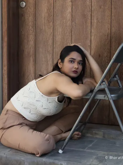 This creative portrait uses a chair as a prop to create interesting lines and a dynamic, low-angle composition.