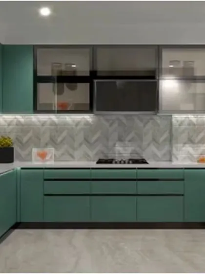 A U-shaped kitchen in a beautiful muted green. The design features a mix of solid and frosted glass upper cabinets for varied storage options.