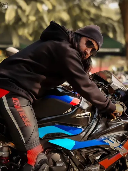 A shot capturing the rider getting on his bike, adding a sense of action and anticipation.