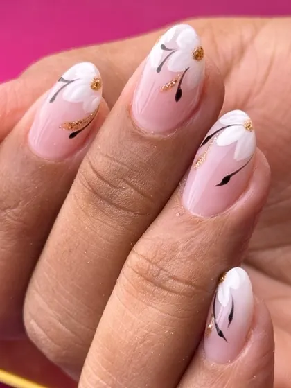 A minimalist and chic floral design. Simple white flowers with black stems and a touch of gold glitter are painted on a clean, natural base.