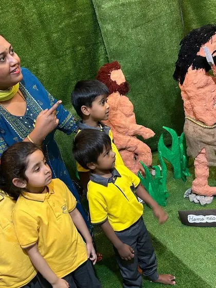 A teacher engages students with the human evolution models, telling the story of our ancestors. History comes alive through storytelling and hands-on exploration.