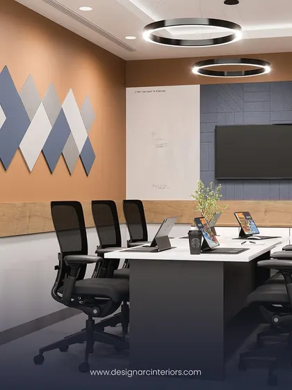 A render of a smaller, more intimate meeting room. The design uses a warm color palette and geometric wall panels to create a focused and comfortable environment for small group discussions.