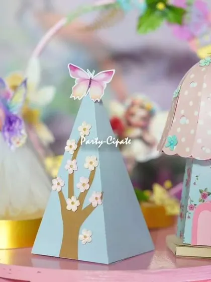 Miniature handcrafted props for a fairy party. These tiny, detailed houses and trees are perfect for adding depth and charm to the dessert table.