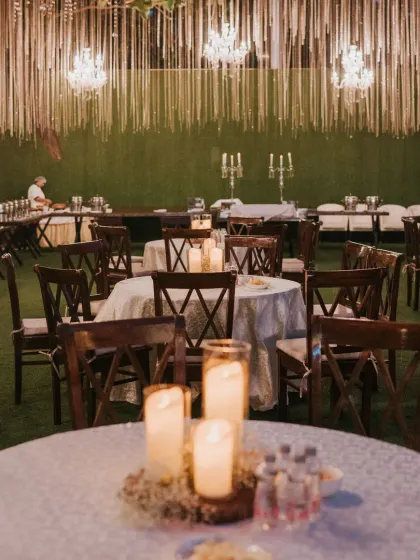 The ambiance of this outdoor reception was pure magic. We used a canopy of string lights, crystal chandeliers, and candlelit centerpieces on each table to create a warm, intimate, and incredibly romantic dining experience for the guests.