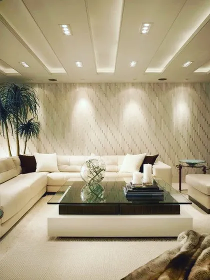 This expansive, all-white sectional sofa creates a serene and luxurious atmosphere. The deep, comfortable cushions and ample seating make it the perfect centerpiece for a large, modern living room designed for relaxation and social gatherings.