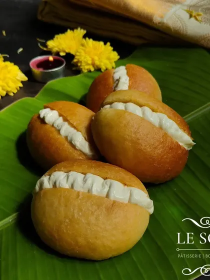 A close-up of my baked Butter Buns, showcasing their golden-brown crust and fluffy cream filling. A guilt-free indulgence from my Onam collection.