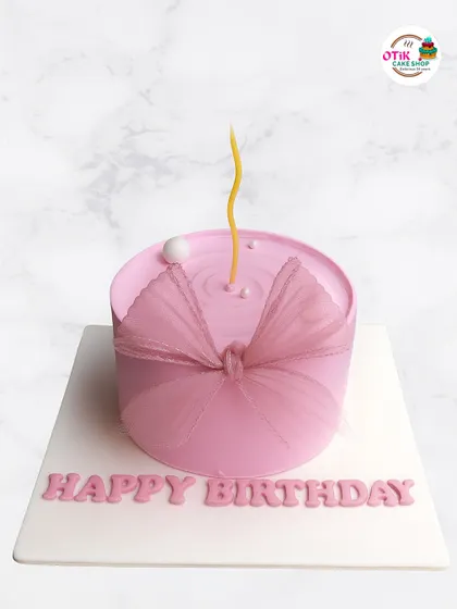 Simplicity at its finest. This minimalist pink cake features a subtle ripple effect on top and a delicate tulle bow, proving that sometimes less is more when it comes to elegant design.