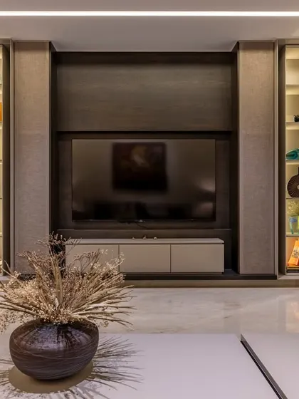 This custom media unit features backlit display shelves, providing the perfect showcase for art and collectibles. The design balances aesthetics with storage, keeping the living area organized and stylish.