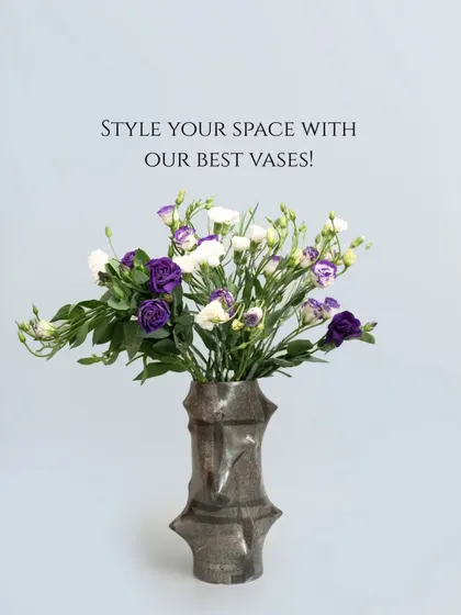 A single, spiky vase in a metallic finish holds a bouquet of purple and white flowers. This piece shows how a vase with a strong personality can elevate even the simplest floral arrangement.