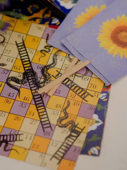 We even customized the games. This traditional snakes and ladders board was redesigned with our event's color palette and motifs, providing a fun and on-theme activity for guests.