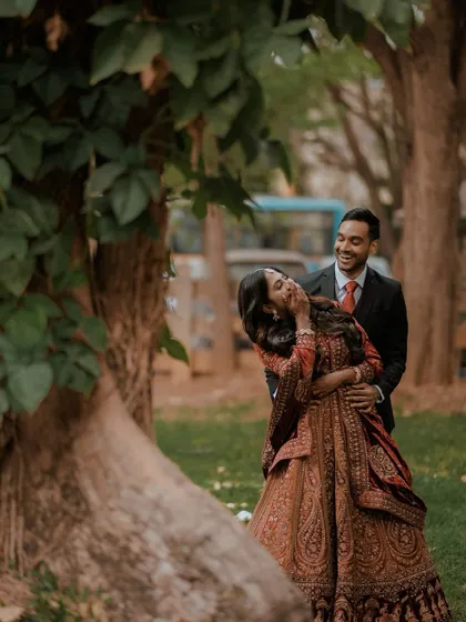 A candid shot of the couple sharing a laugh during their reception photoshoot.