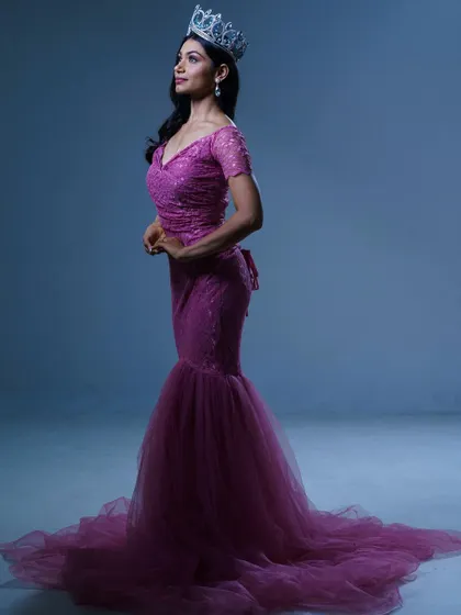 A side profile of the pink mermaid gown, showing the elegant train and the beautiful way the fabric drapes.