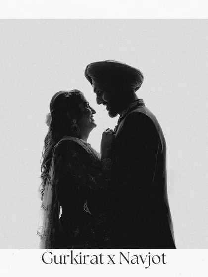 A classic black and white silhouette of the couple, capturing a moment of shared laughter and joy. The simplicity of the shot emphasizes their connection.
