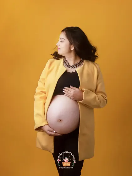 The styling with the statement necklace adds another layer to this contemporary maternity portrait, showing that you can be pregnant and fashionable.