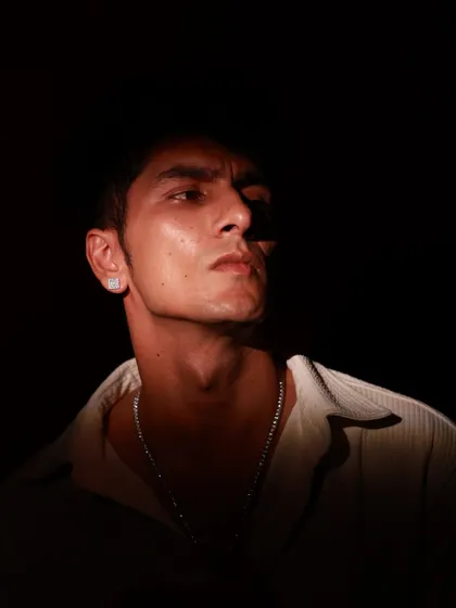 A powerful upward gaze, with the light catching the underside of the model's jaw. This unconventional angle creates a strong and commanding portrait.