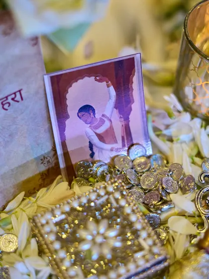 A close-up of the decor, showing a miniature painting, scattered coins, and a jeweled box, all contributing to the rich, historical theme.