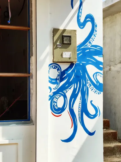 We even incorporated the building's features into our design, with this octopus mural cleverly wrapping around a utility box for a seamless look.