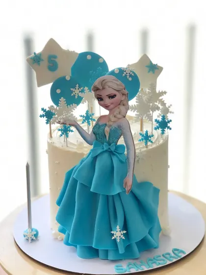 A single-tier version of my Elsa cake, complete with a beautiful dress and sparkling snowflake decorations.