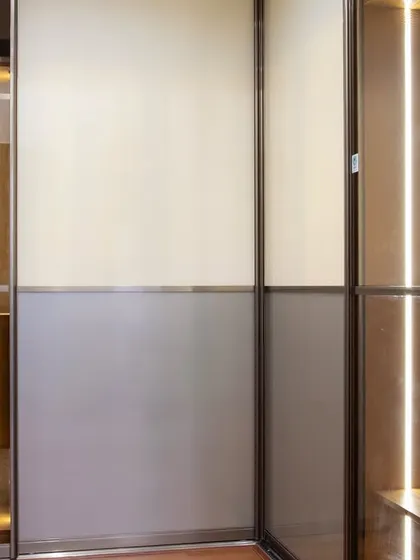 Here you can see the interior of the sliding wardrobe, with organized shelving and drawers in a warm wood finish. The integrated lighting ensures every corner is visible, making it effortlessly functional.