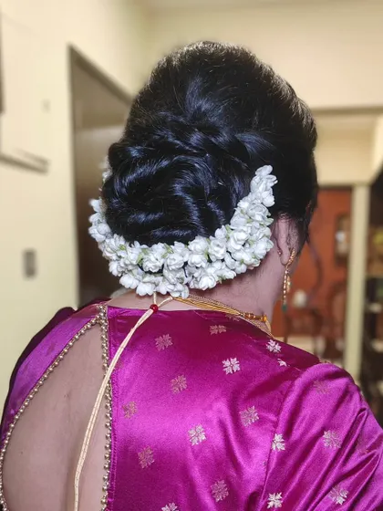 A traditional low bun wrapped in a beautiful gajra of fresh jasmine. The fragrance and look of this hairstyle are quintessentially Indian and always elegant.