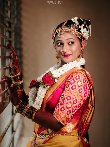 A stunning close up portrait of the bride by the window. The lighting beautifully highlights her features and the details of her jewelry.