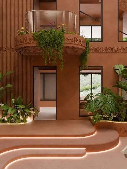 The central courtyard, with its terracotta walls and intricate Kalamkari detailing, is the heart of the design. Balconies spill over with lush greenery, softening the lines and creating a rhythm of nature against earth.
