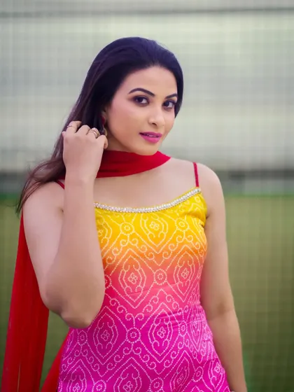 A close-up portrait focusing on the model's happy expression and the vibrant colors of her outfit.