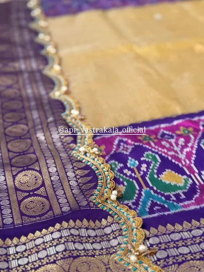 A scalloped saree border with turquoise and gold embroidery.