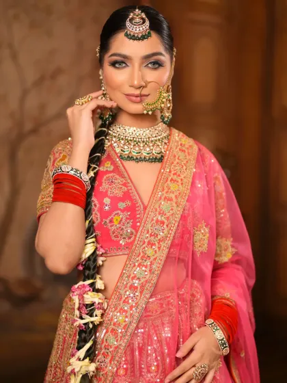 This portrait showcases the complete look, from the detailed eye makeup and nude lips to the traditional nose ring and maang tikka. It's a modern take on a classic bridal style.